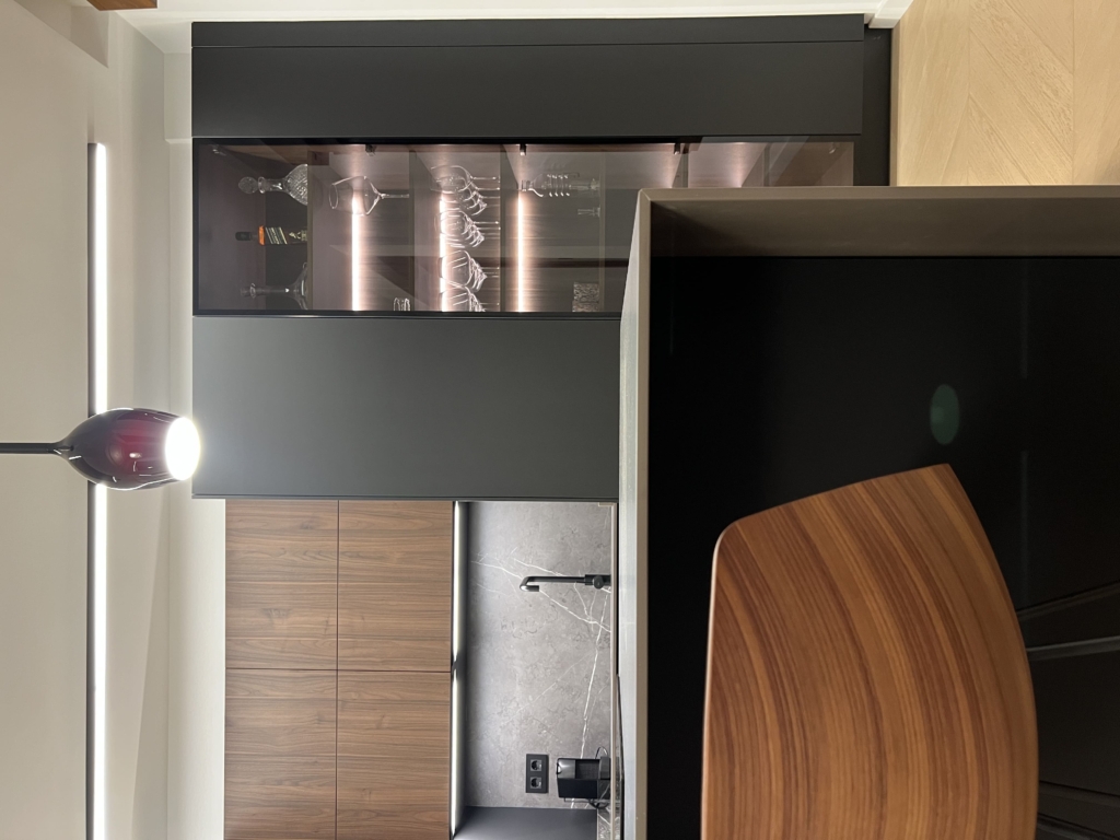 Cocina Santos en negro y nogal con columna vitrina iluminada Cocina Santos en negro y nogal con columna vitrina iluminada elegante